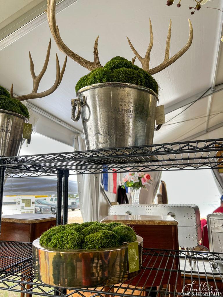 Silver wine bucket holding moss and antlers