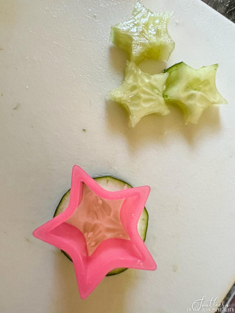 Cutting cucumber stars with a cookie cutter