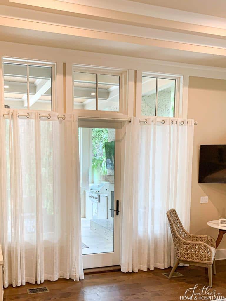 Windows and door with white gauzy drapes