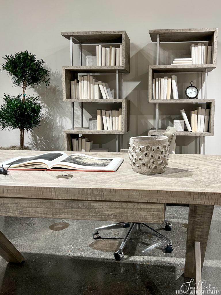 Desk and bookcases with neutral covered books