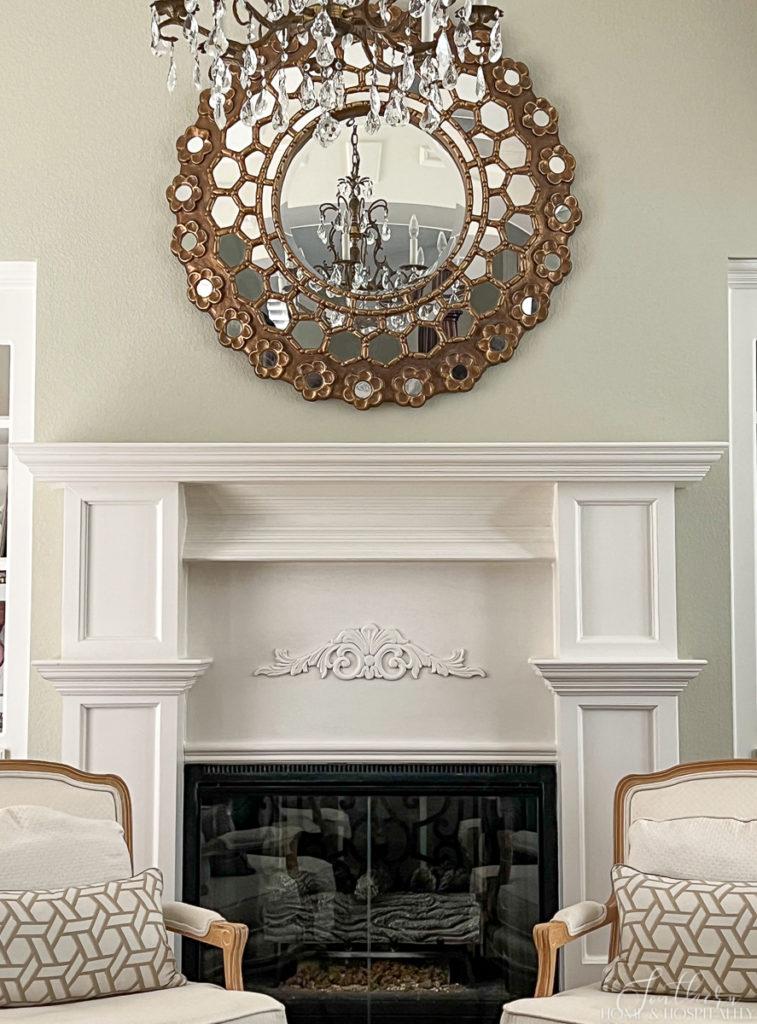 French country fireplace and starburst mirror and empty mantel