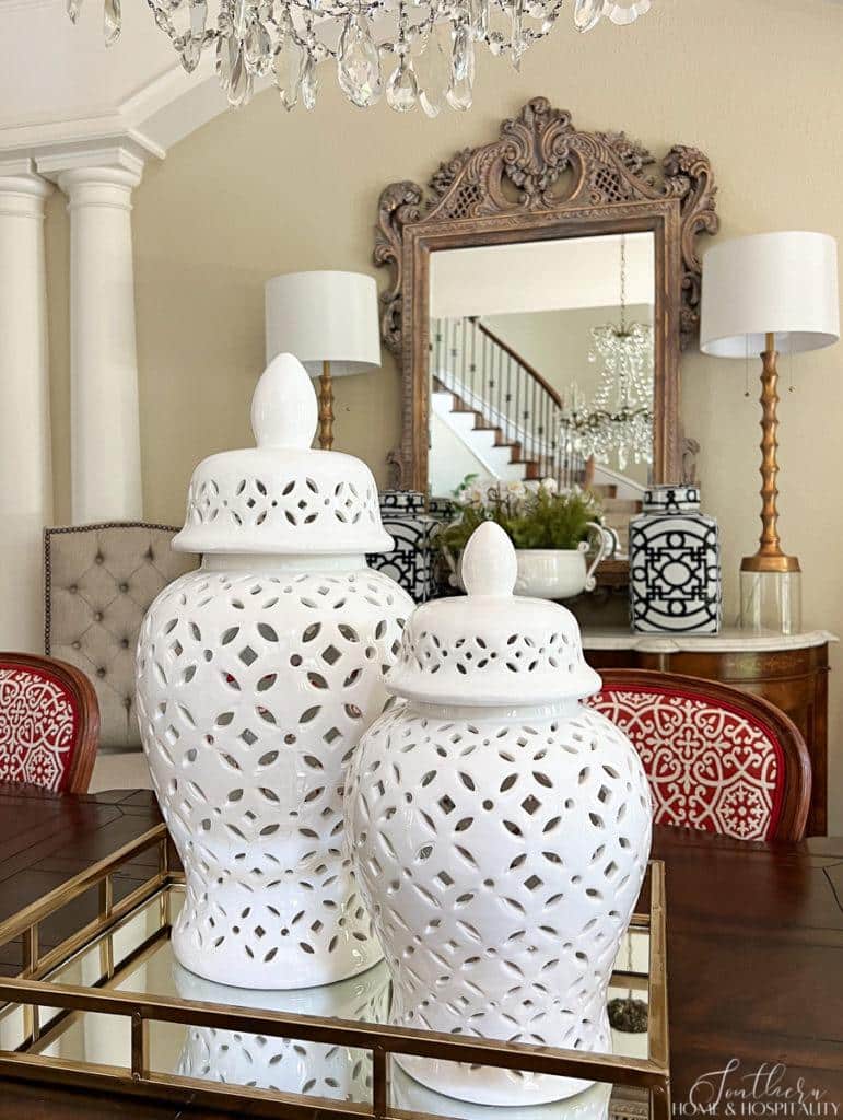 Dining table centerpiece with large white ginger jars