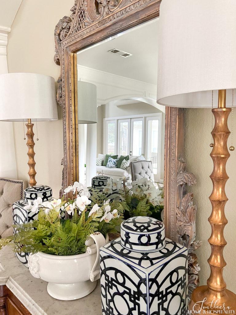 ferns and orchids in a pedestal bowl, blue and white ginger jars