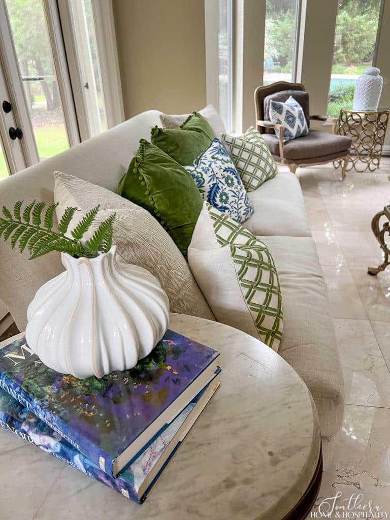 Fern in white vase in blue, green, and white living room