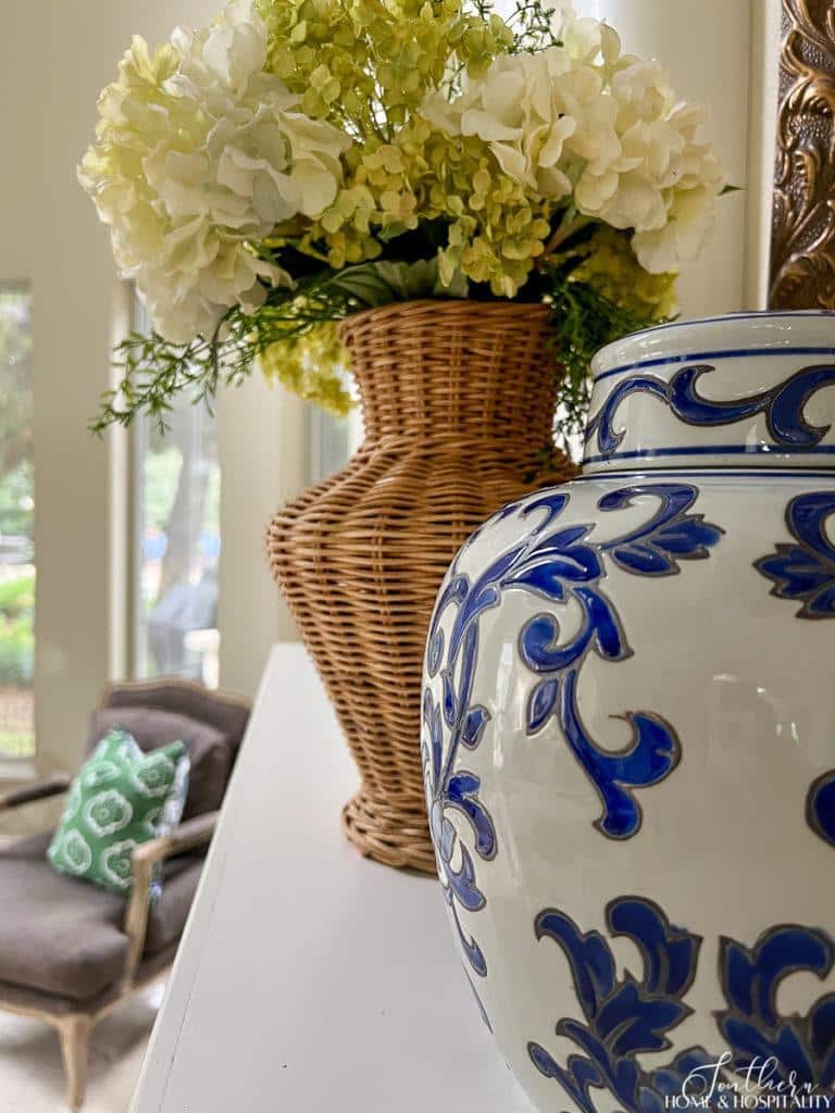 Wicker vase with hydrangeas, blue and white temple jar