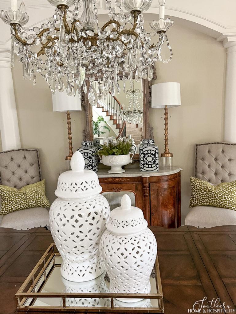 Vintage French chandelier and white ginger jars on dining table