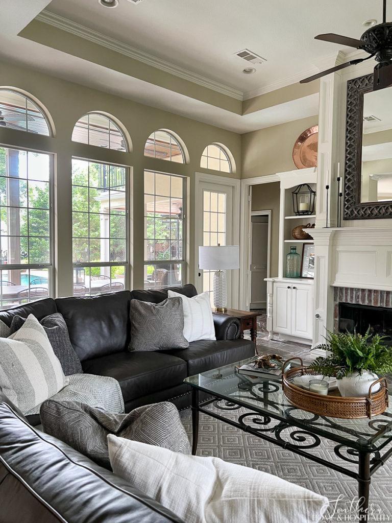 Family room with neutral walls in Accessible Beige and dark neutral leather sofa