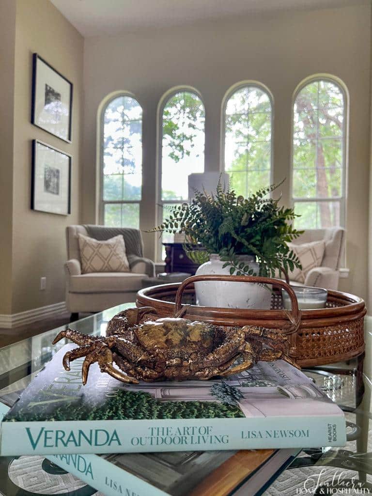 Summer coffee table decor with gold crab and Veranda coffee table books
