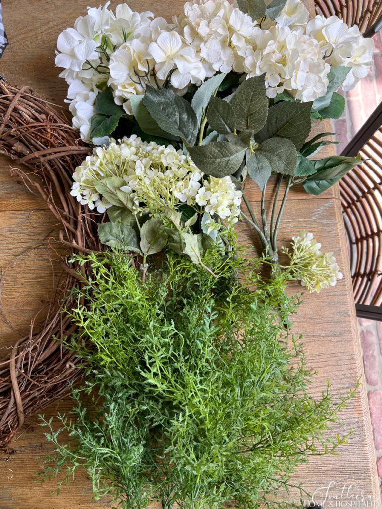 Faux white hydrangeas and asparagus fern stems for summer wreath