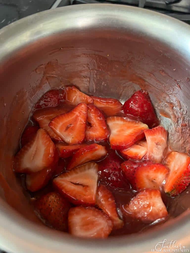 sliced strawberries in sauce