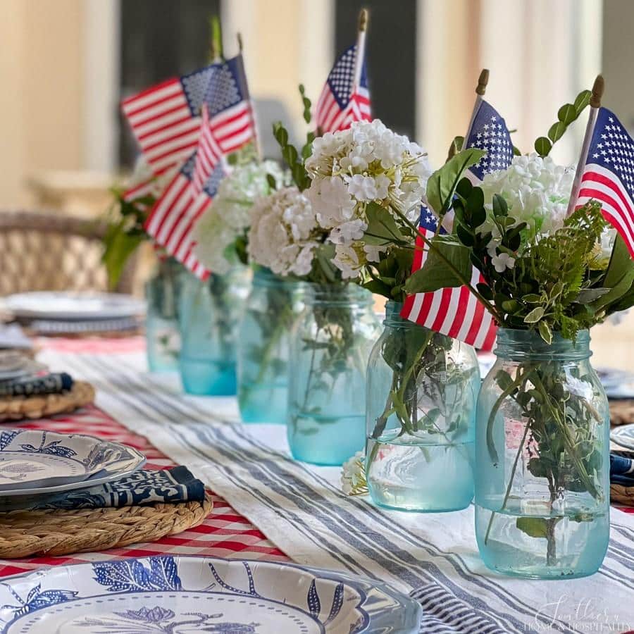 Mason jars painted with sea glass paint in a Fourth of July centerpiece