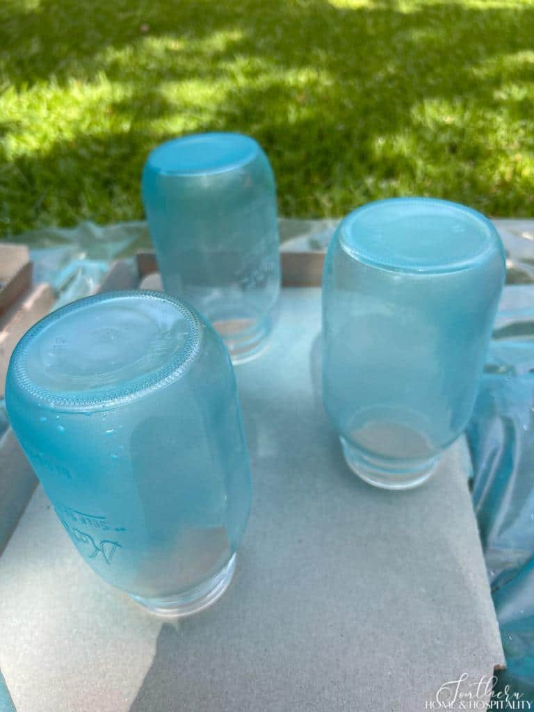 Mason jars painted with aqua sea glass spray paint