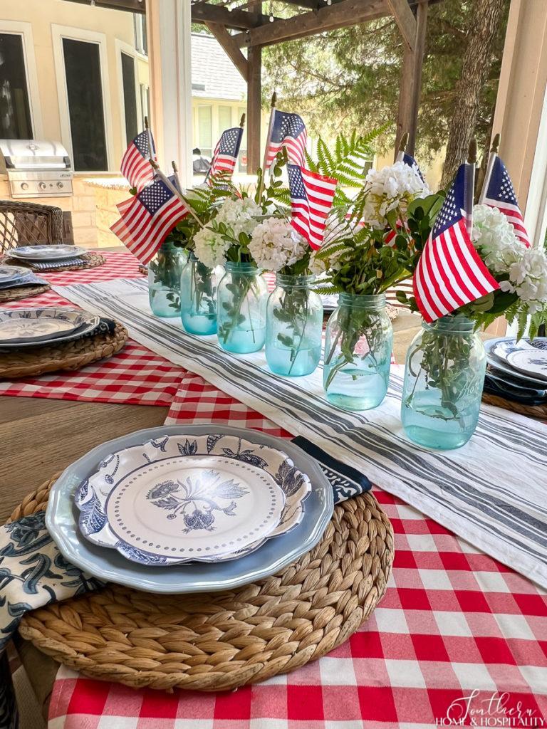 Mason jars painted with sea glass paint in a Fourth of July centerpiece