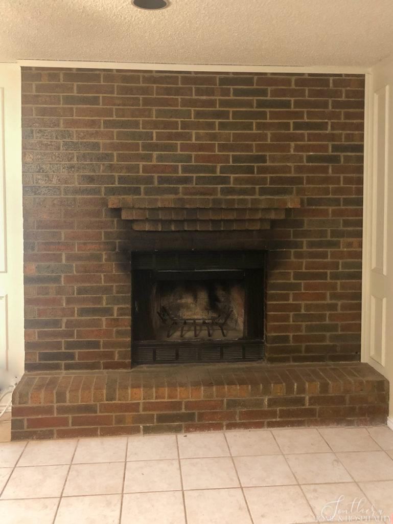 Dark brick fireplace before whitewash