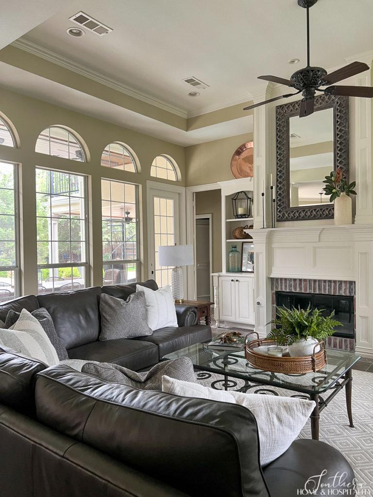 traditional family room with leather sectional and neutral throw pillows