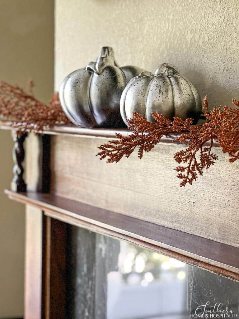 Ceramic pumpkins painted with mirror effect spray paint to look like aged metal