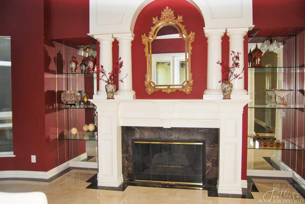 burgundy wall paint and white fireplace mantel