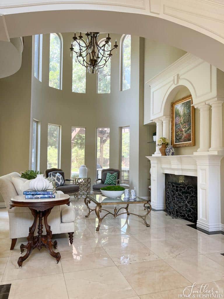 two story living room, white wood fireplace surround with columns