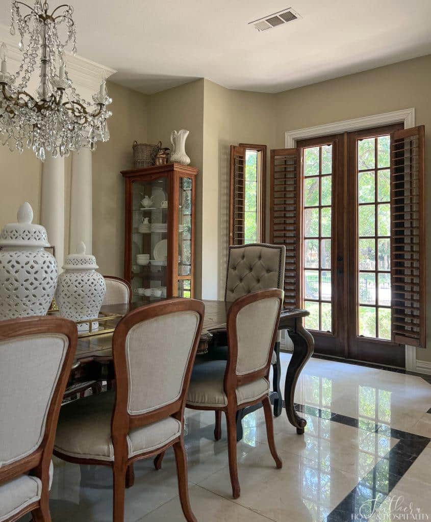 French doors in dining room with stained wood plantation shutters