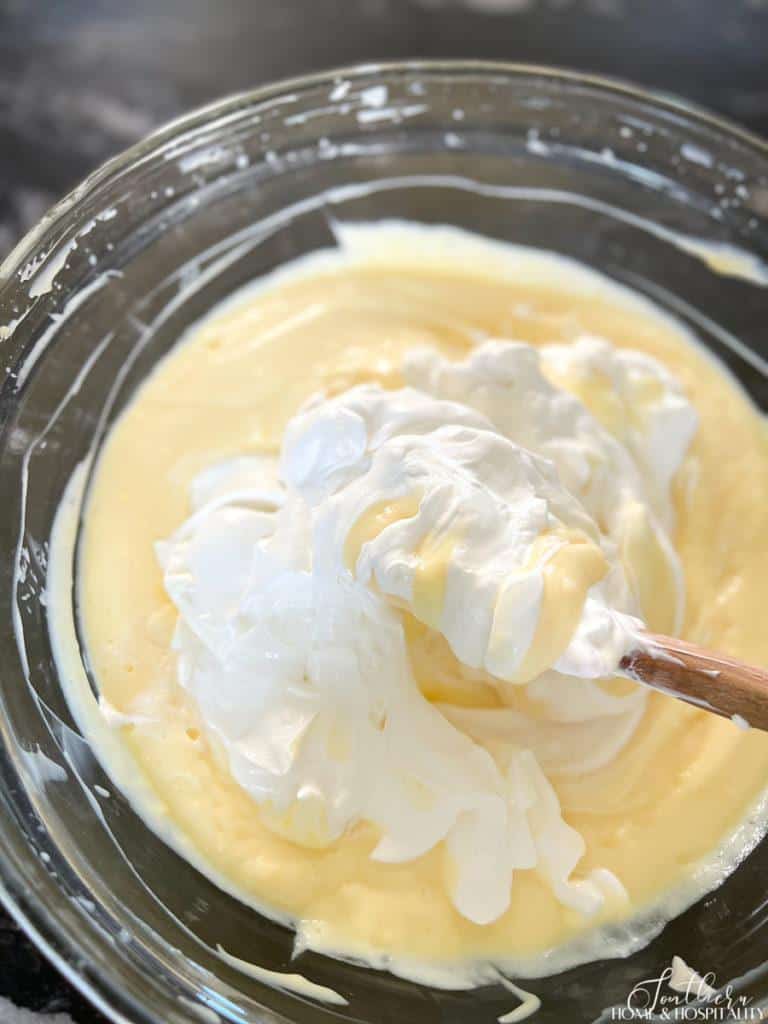 folding sour cream and whipped topping into pudding