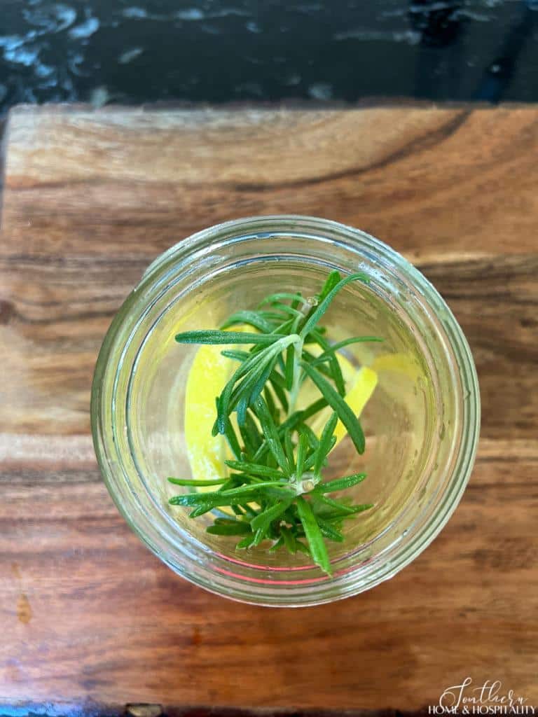 rosemary and lemon in a mosquito repellent mason jar candle