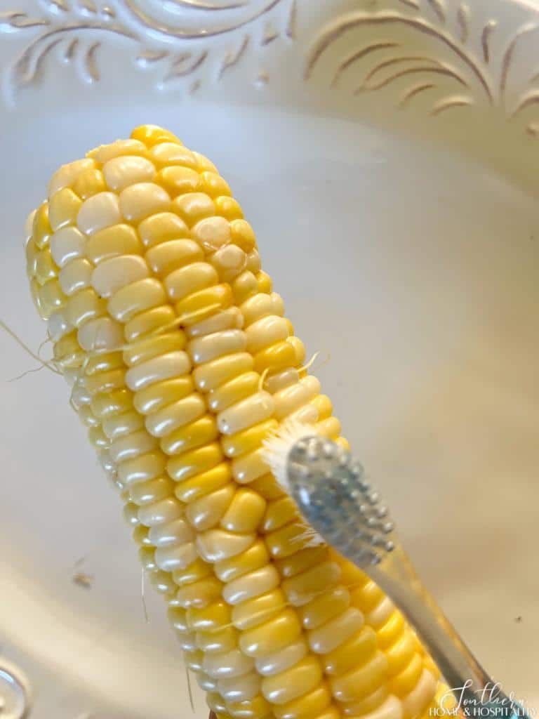 cleaning silks off corn with toothbrush