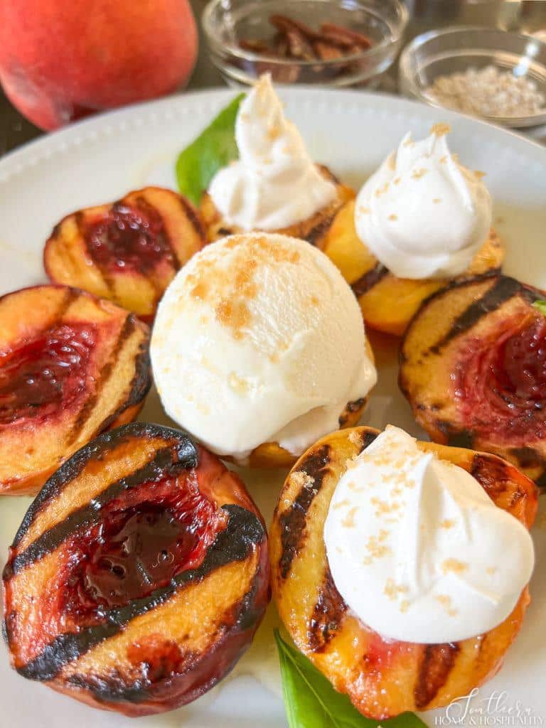 Grilled peaches with vanilla ice cream and whipped cream