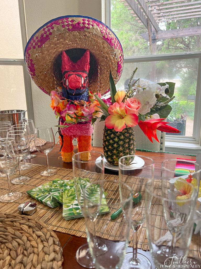 Margaritaville table centerpiece with pinata and pineapple vase of flowers