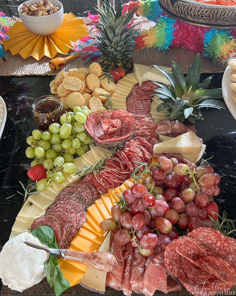 charcuterie board with pineapple crowns
