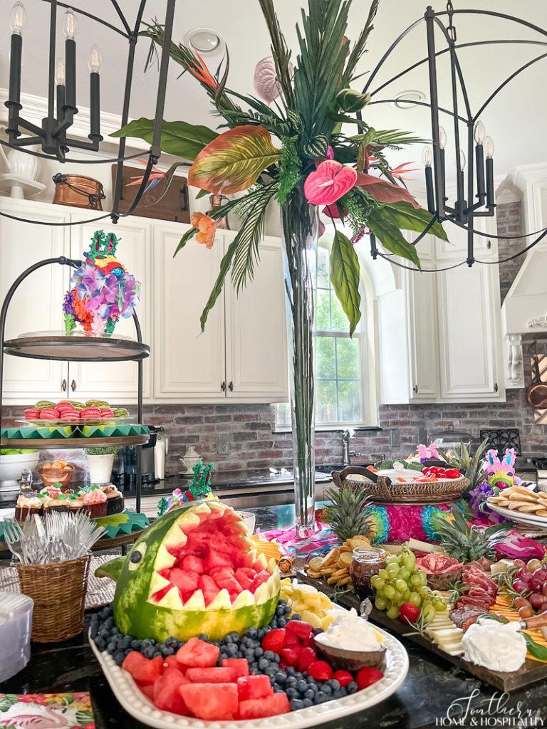 tall tropical centerpiece, watermelon shark, and tropical appetizer buffet