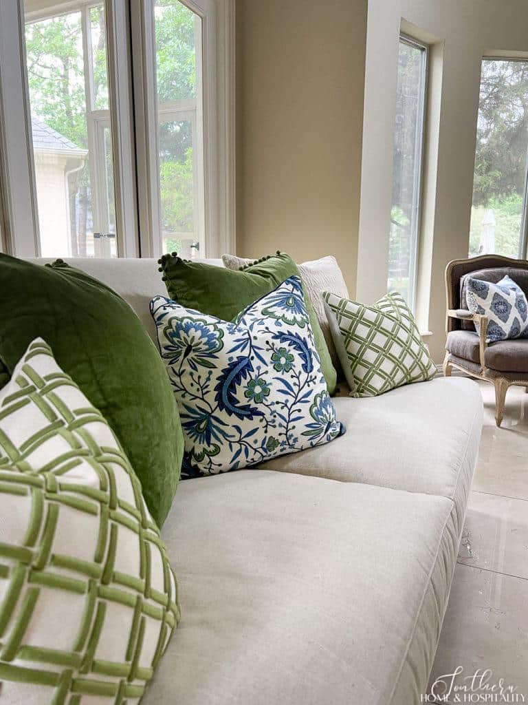 Blue and green throw pillows on linen sofa