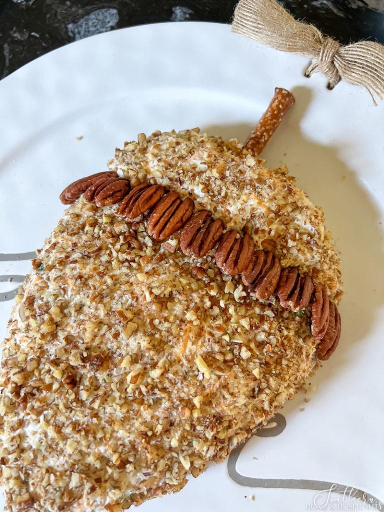making acorn cap with pecans on acorn cheese ball