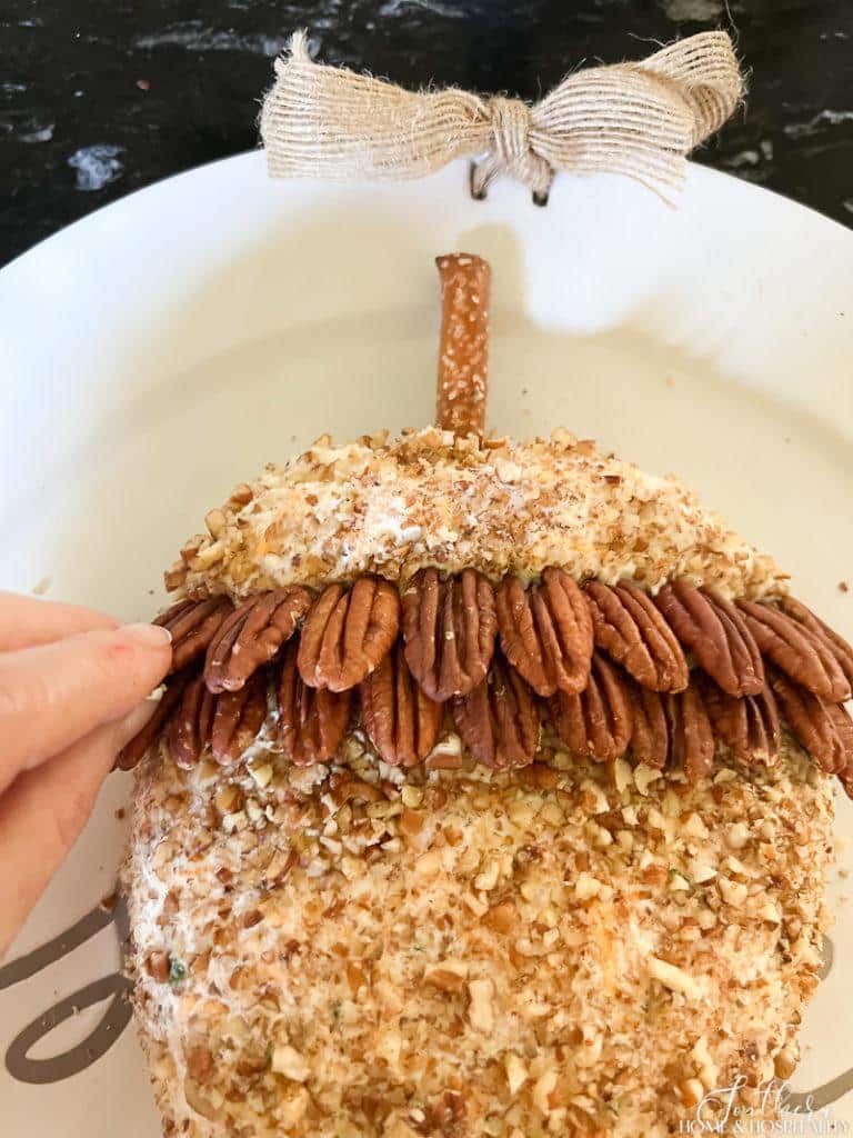 making acorn cap with pecans on acorn cheese ball