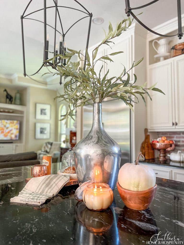dried eucalyptus leaves in vase with pumpkins in kitchen