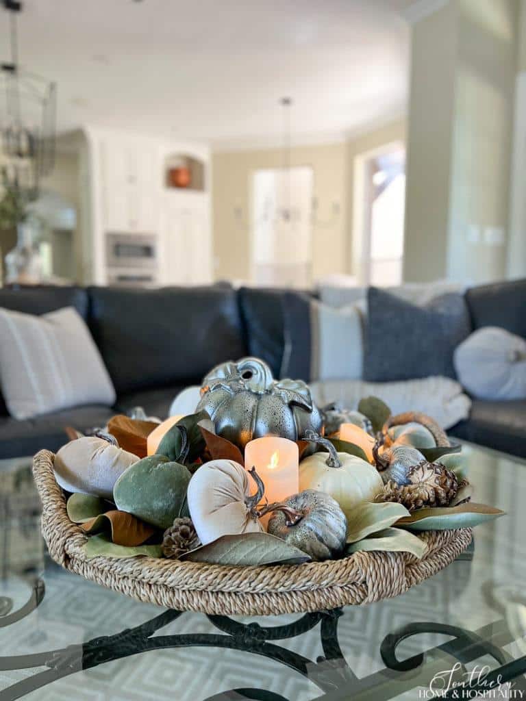 Fall coffee table centerpiece with pumpkins and candles