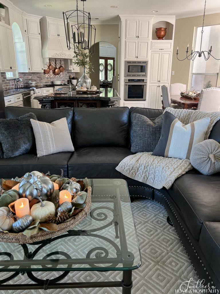 Sectional sofa with fall pillows, fall coffee table arrangement