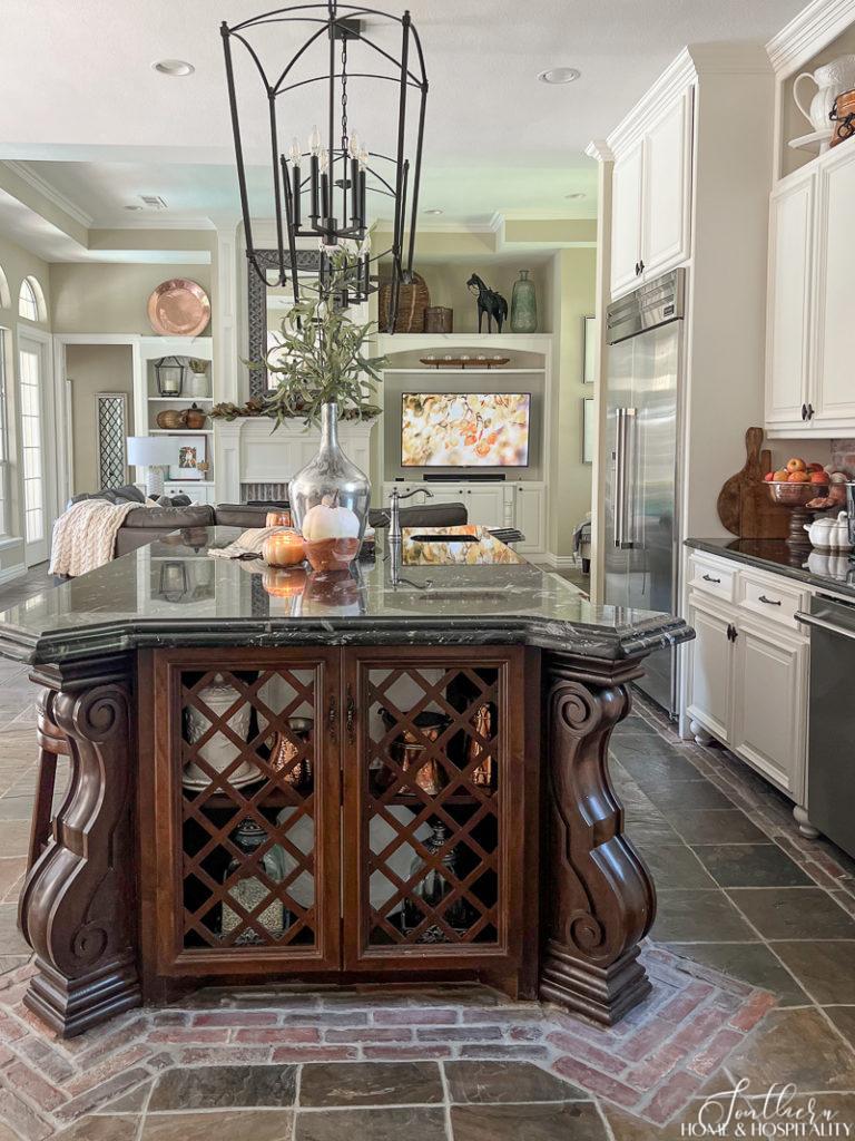 kitchen island with fall branches and pumpkins