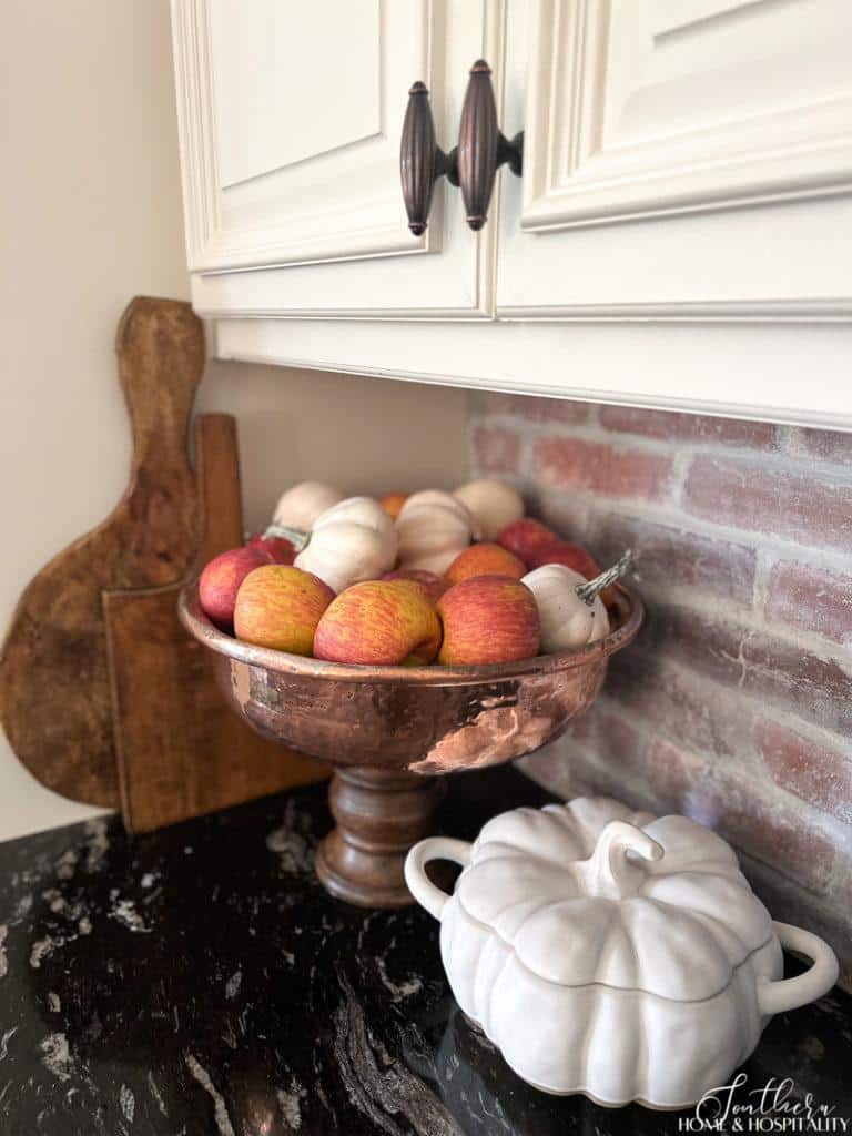 Apples and pumpkins in a copper bowl