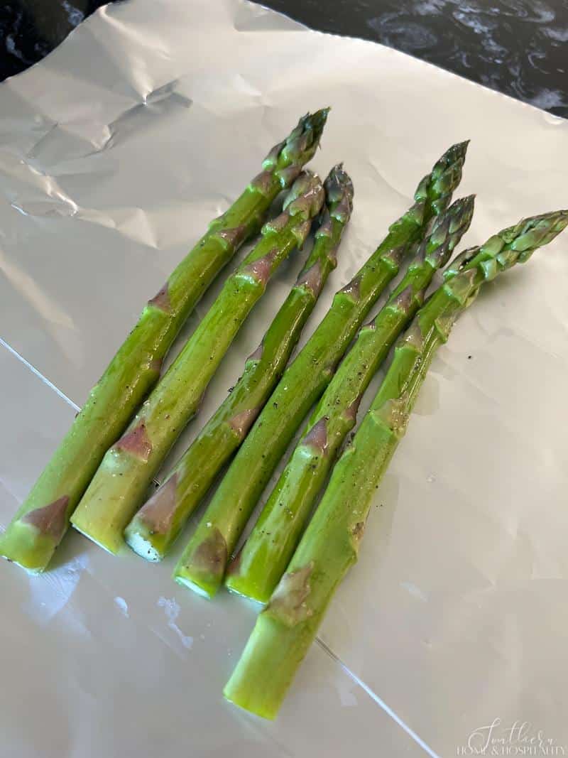 Asparagus spears laid out on foil sheet