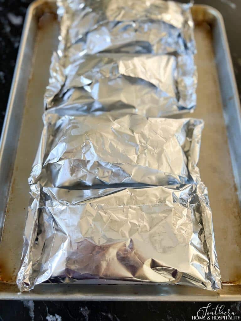 Salmon foil packets on baking sheet