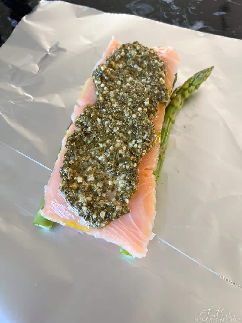 Basil pesto spread on salmon filet