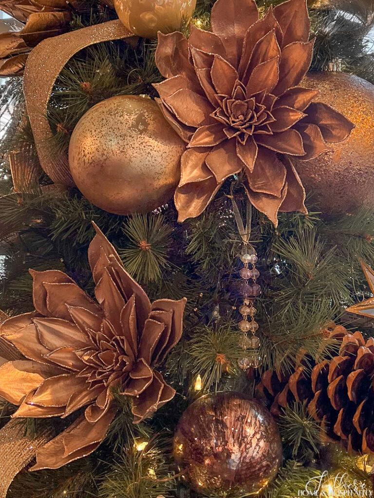 Bronze metallic flowers and ornaments on a Christmas tree