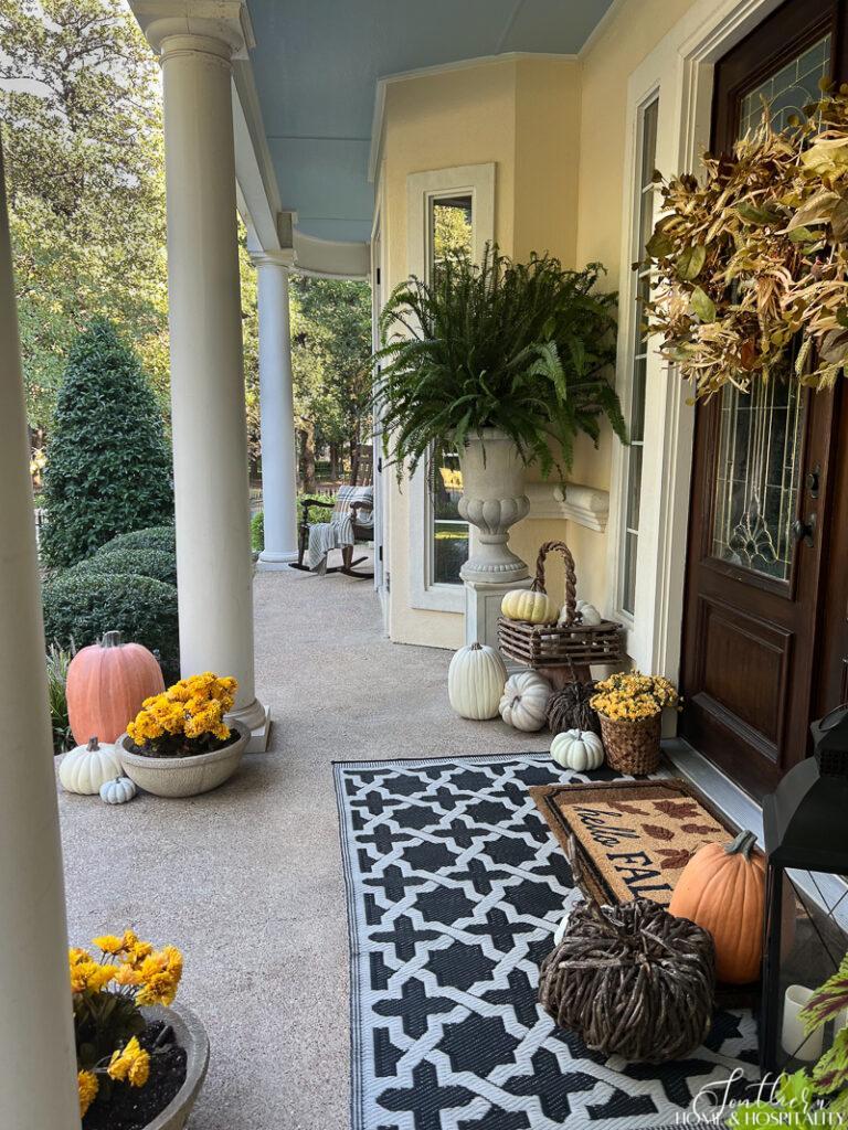 Front porch with pumpkins and mums for budget-friendly fall curb appeal