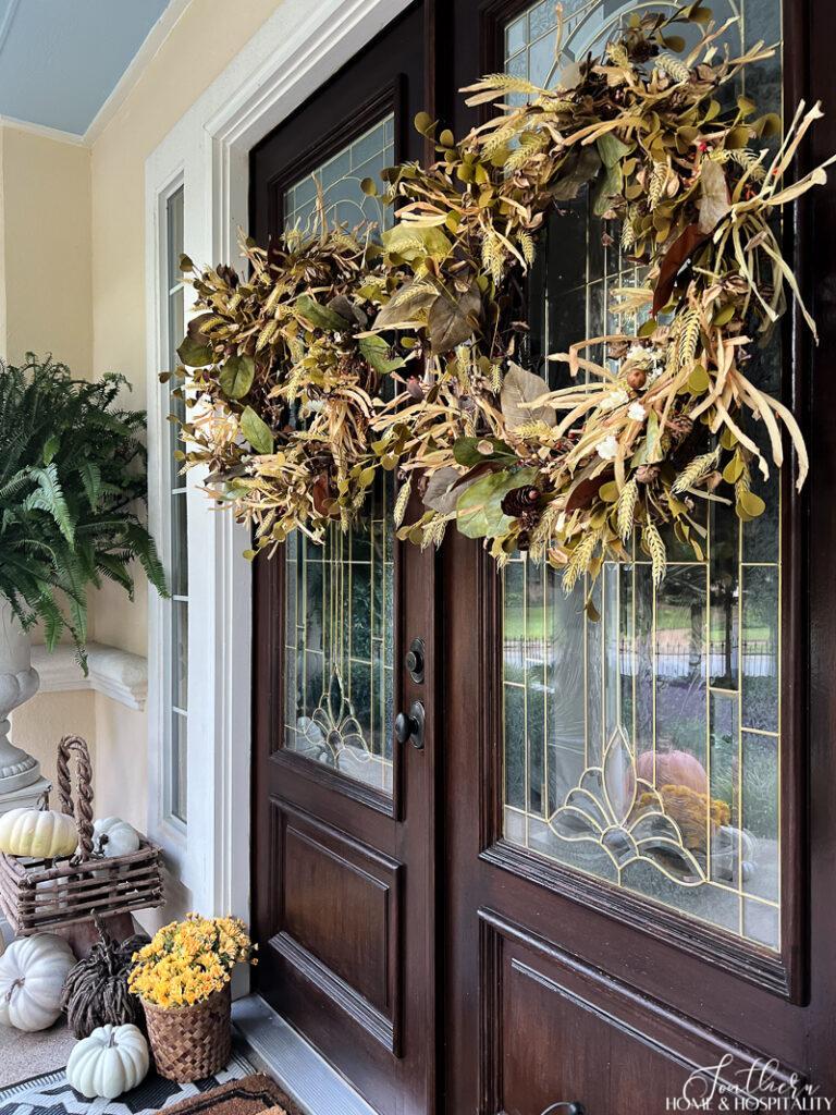 Double front doors with fall wreaths