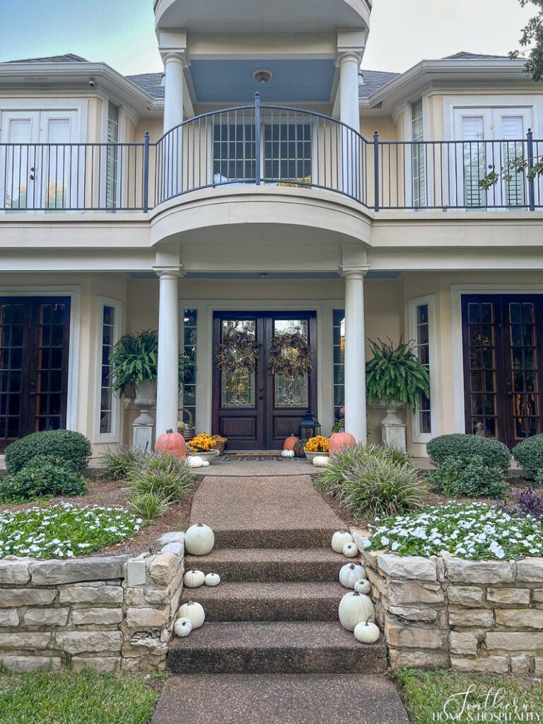 Front porch with pumpkins and mums