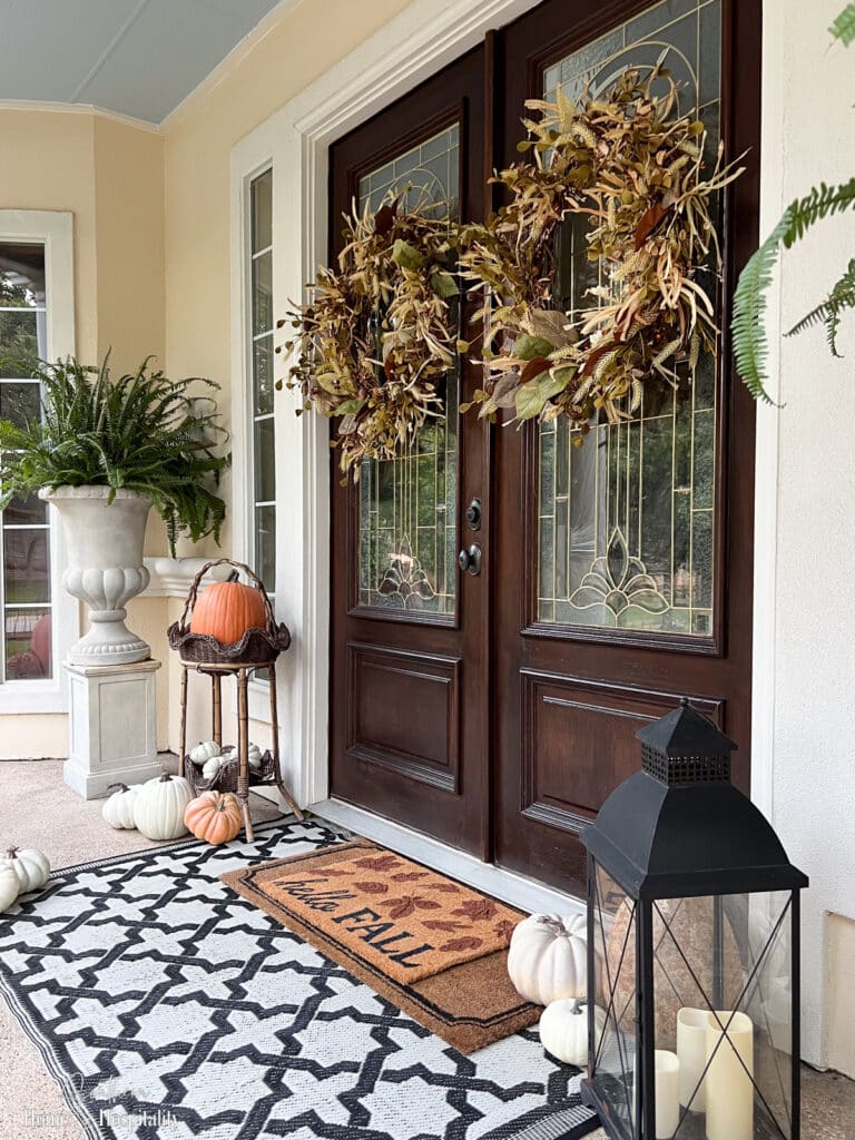 Southern porch decorated for fall with pumpkins