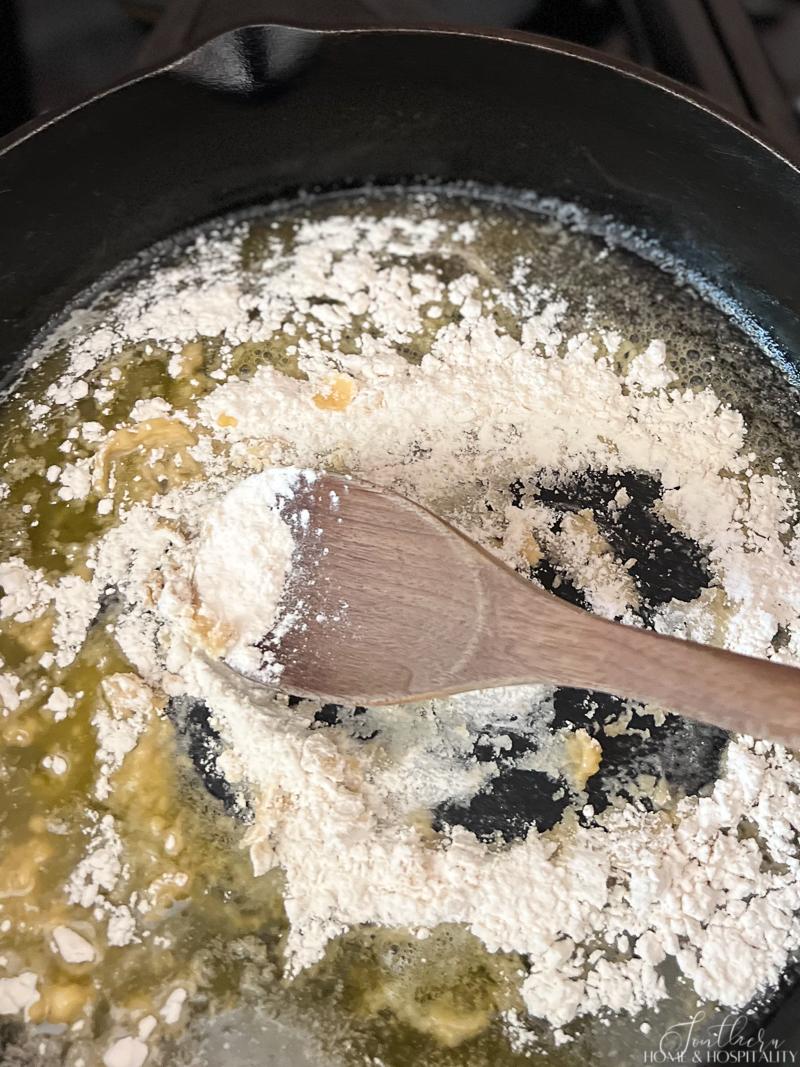 Mixing flour in butter to make a roux