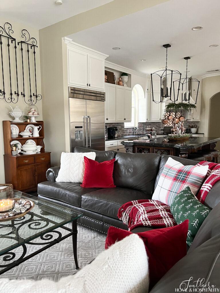 Leather sectional with red, white, and green Christmas pillows