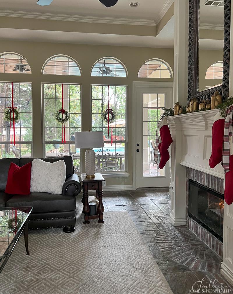 Fireplace with vintage bells and red velvet stockings on mantel