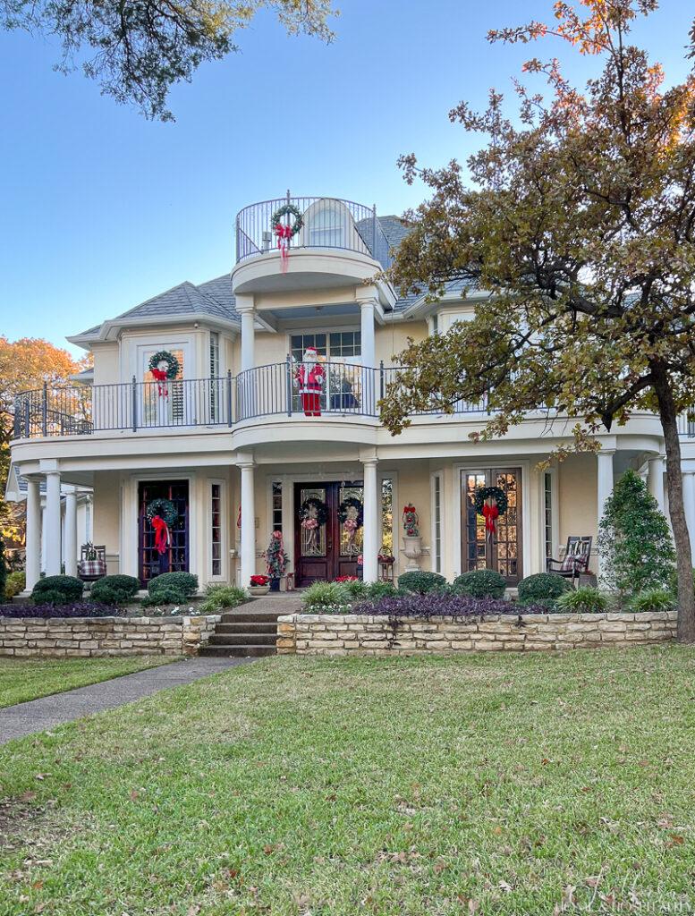 Southern home decorated with red and white and wreaths on the windows